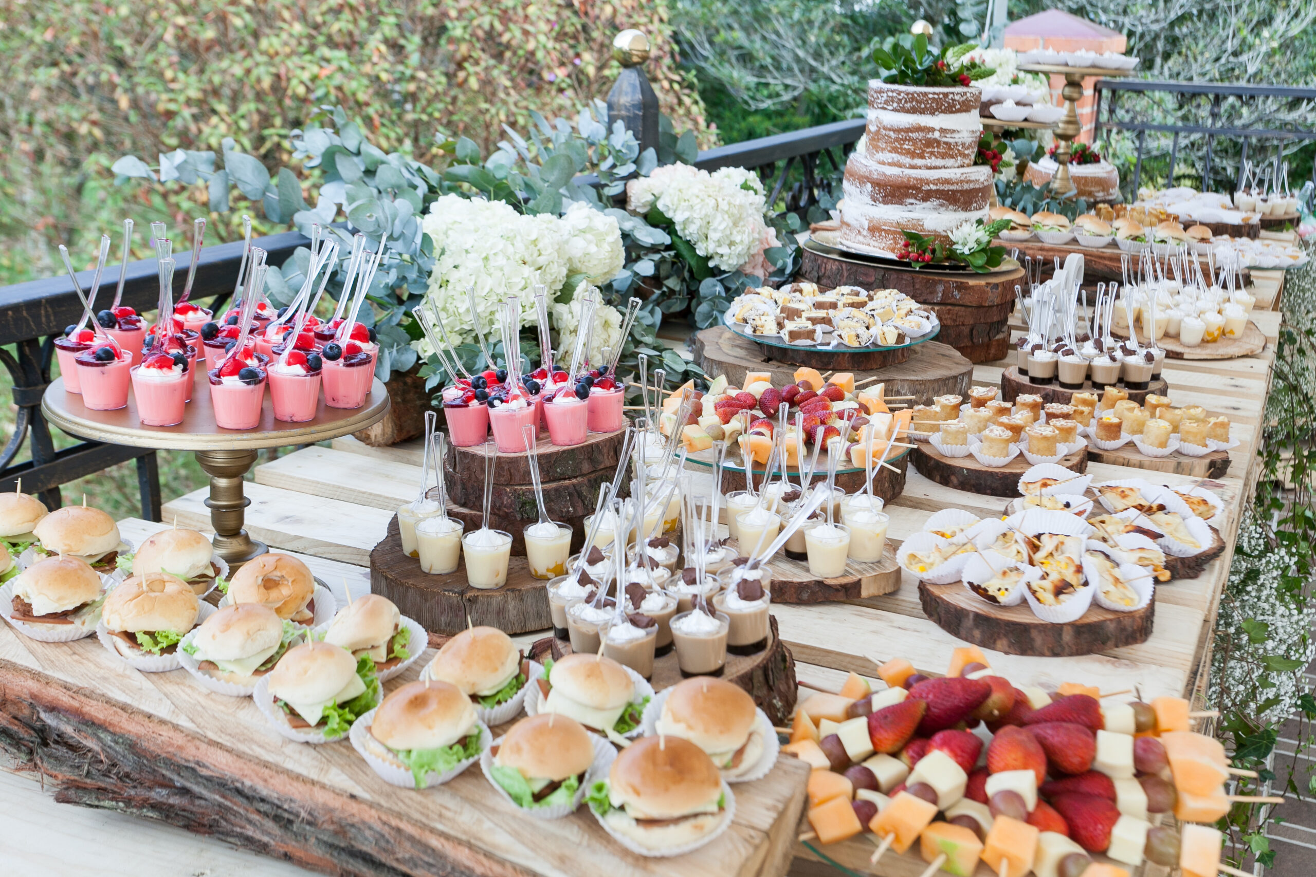 Table decorated with desserts, snacks and cake - wedding reception for event guests.